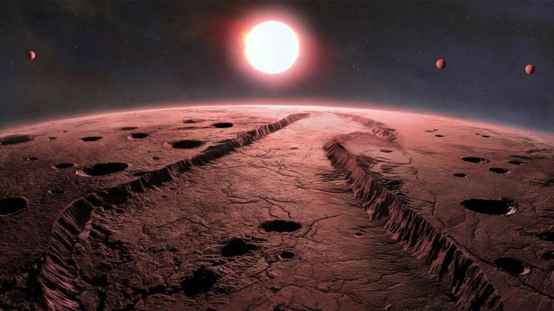 A red sun and three planets hang over the horizon of a red rocky planetary surface.
